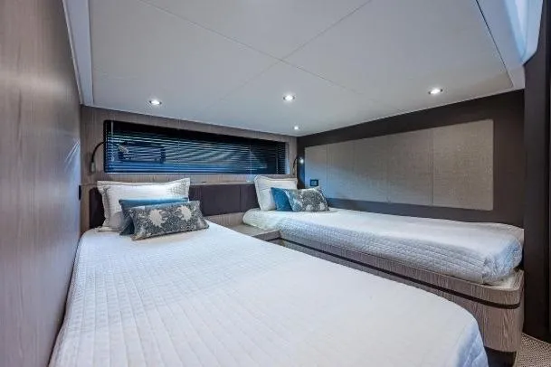 Slide: The Image of Luxurious twin cabin interior of 2022 Azimut Atlantis 45 yacht, featuring modern design and cozy bedding. - 38