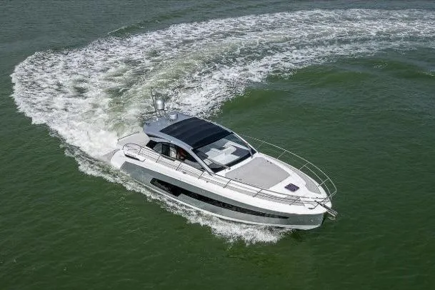 Slide: The Image of 2022 Azimut Atlantis 45 yacht cruising on open water, creating a wake. - 8