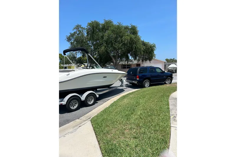 Slide: The Image of 2020 Sea Ray SPX 210 Outboard boat on trailer under cloudy sky. - 10