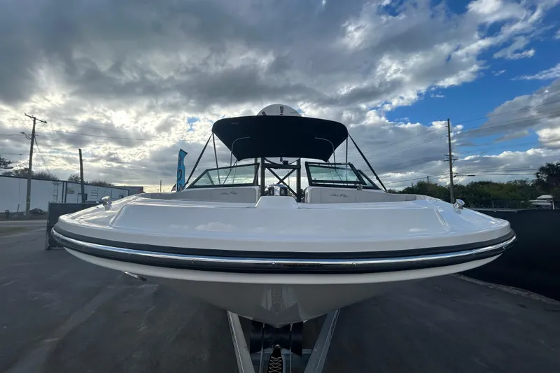 Slide: The Image of 2020 Sea Ray SPX 210 Outboard boat on trailer under cloudy sky. - 11