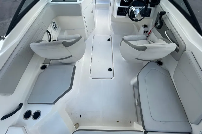 Slide: The Image of 2020 Sea Ray SPX 210 Outboard boat interior with white seating and steering console. - 18
