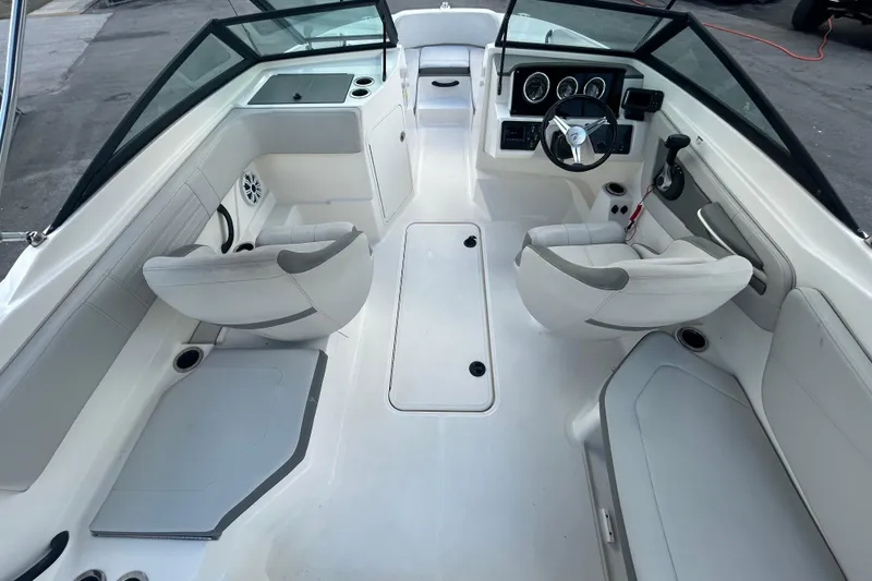 Slide: The Image of 2020 Sea Ray SPX 210 Outboard boat interior with white seating and modern dashboard. - 19