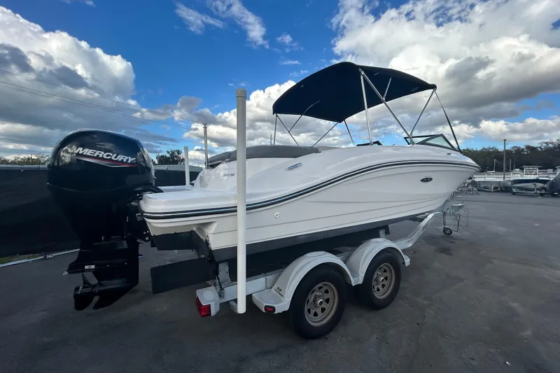 Slide: The Image of 2020 Sea Ray SPX 210 Outboard boat on trailer under cloudy sky. - 2