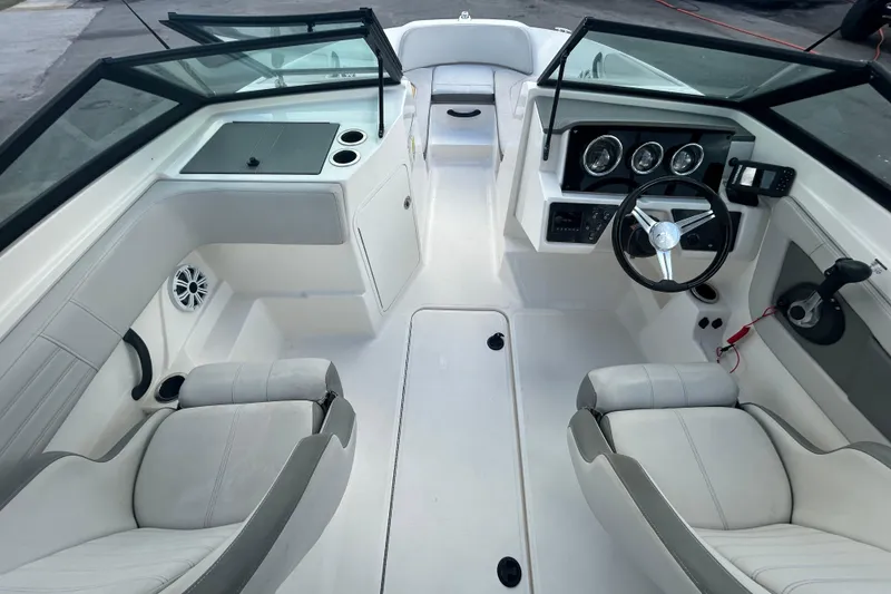 Slide: The Image of 2020 Sea Ray SPX 210 Outboard boat interior with steering wheel and seating. - 20