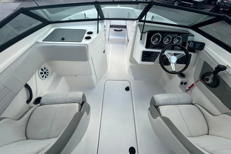 Slide: The Image of 2020 Sea Ray SPX 210 Outboard boat interior with steering wheel and seating. - 21