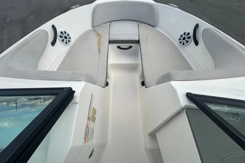 Slide: The Image of 2020 Sea Ray SPX 210 Outboard boat interior with cushioned seating and speakers. - 24