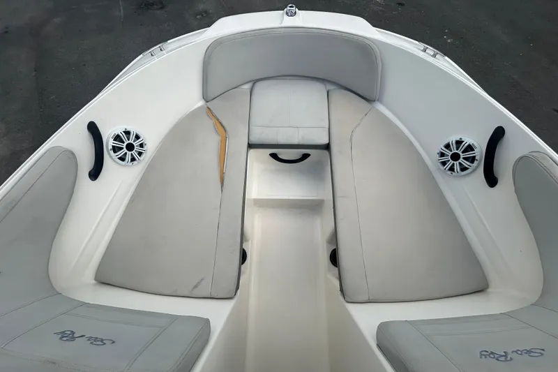 Slide: The Image of 2020 Sea Ray SPX 210 Outboard boat interior with cushioned seating and speakers. - 25