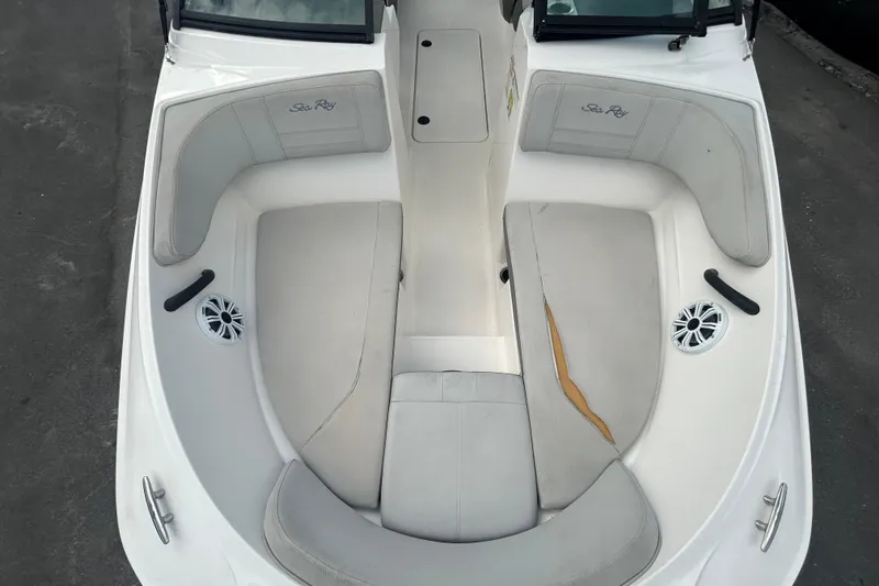 Slide: The Image of 2020 Sea Ray SPX 210 Outboard boat interior with white seating and speakers. - 26