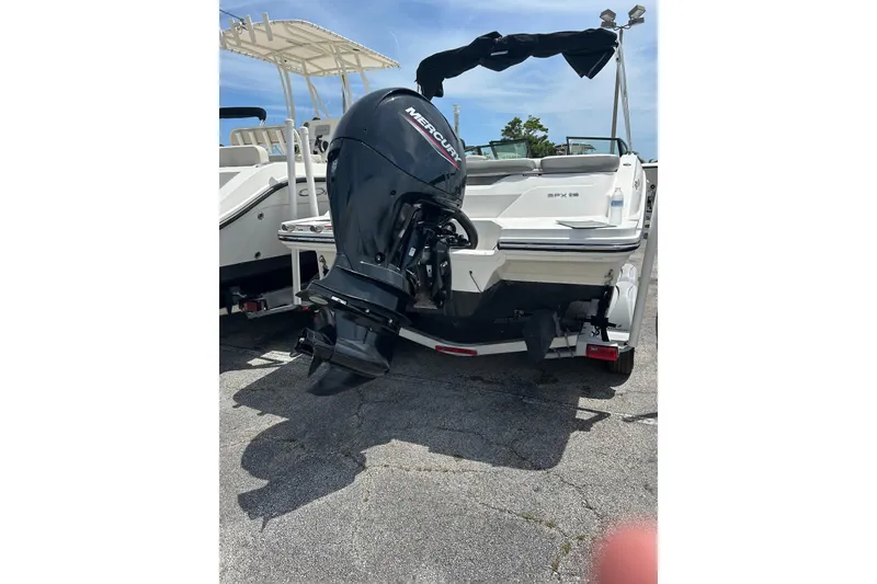 Slide: The Image of 2020 Sea Ray SPX 210 Outboard boat with 150 HP engine, parked outdoors. - 3