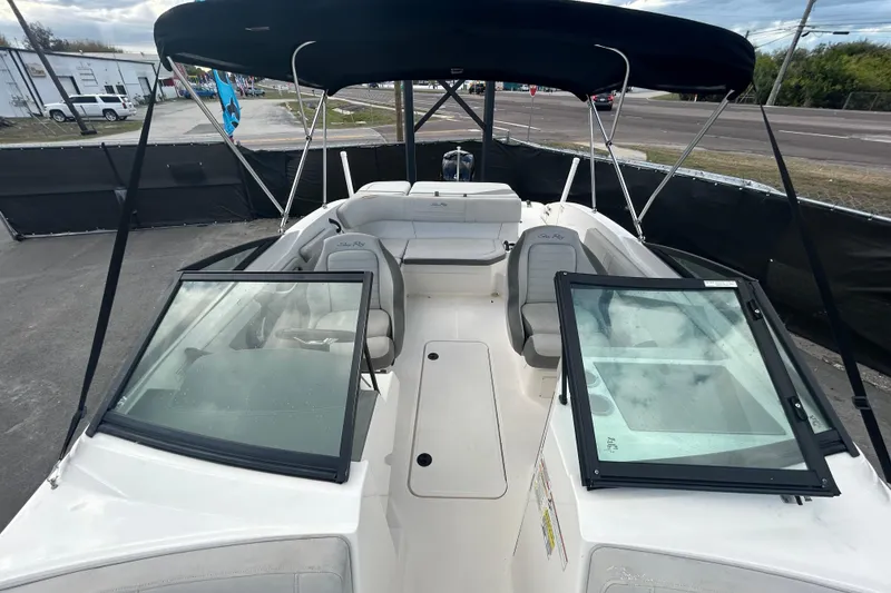 Slide: The Image of 2020 Sea Ray SPX 210 Outboard boat with open deck and seating, under a canopy. - 30