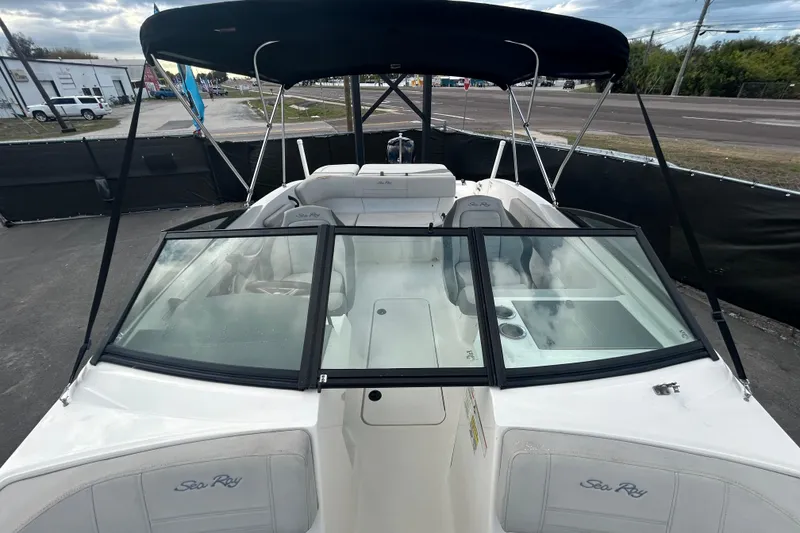 Slide: The Image of 2020 Sea Ray SPX 210 Outboard boat with black canopy and spacious seating. - 31