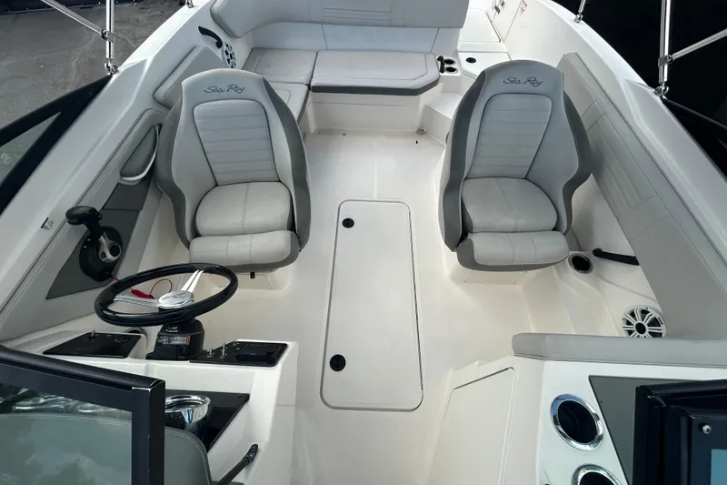 Slide: The Image of 2020 Sea Ray SPX 210 Outboard interior with dual captain seats and steering wheel. - 32