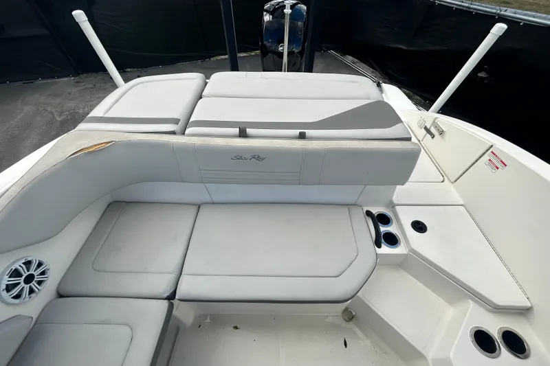 Slide: The Image of 2020 Sea Ray SPX 210 Outboard boat interior with cushioned seating and cup holders. - 35