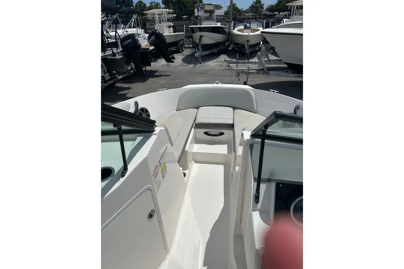 Slide: The Image of Rear view of 2020 Sea Ray SPX 210 Outboard boat on trailer, showing propeller and ladder. - 4
