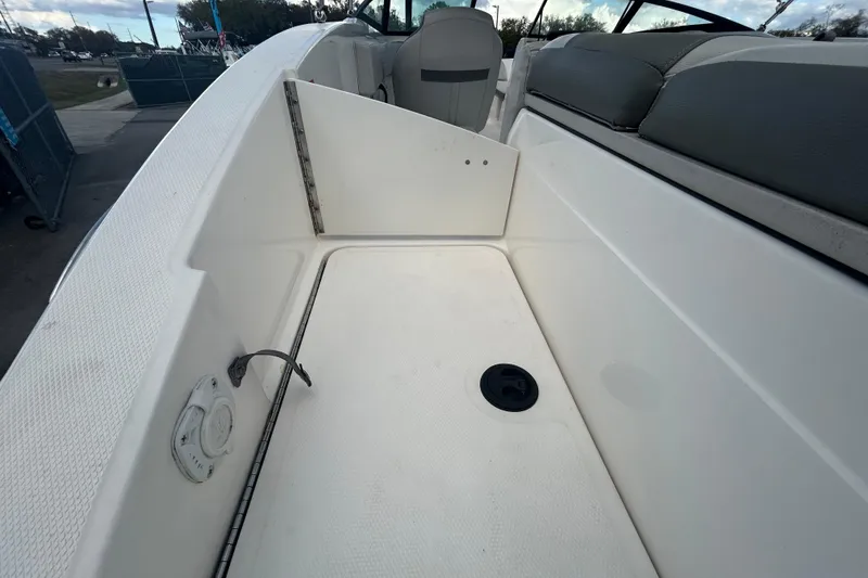 Slide: The Image of 2020 Sea Ray SPX 210 Outboard boat interior, featuring seating and storage area. - 40