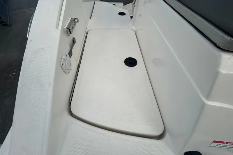Slide: The Image of 2020 Sea Ray SPX 210 Outboard boat interior detail, featuring white deck and fittings. - 41
