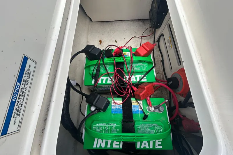 Slide: The Image of Battery compartment of 2020 Sea Ray SPX 210 Outboard with Interstate batteries and wiring. - 43