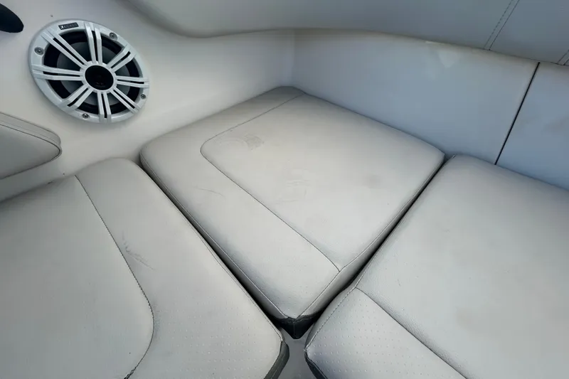 Slide: The Image of 2020 Sea Ray SPX 210 Outboard interior with cushioned seating and speaker. - 48