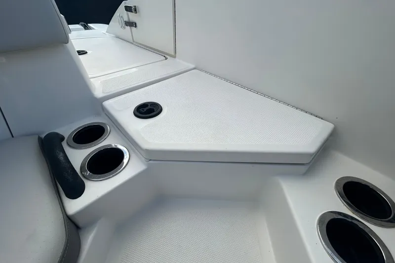 Slide: The Image of 2020 Sea Ray SPX 210 Outboard boat interior with cup holders and seating area. - 54