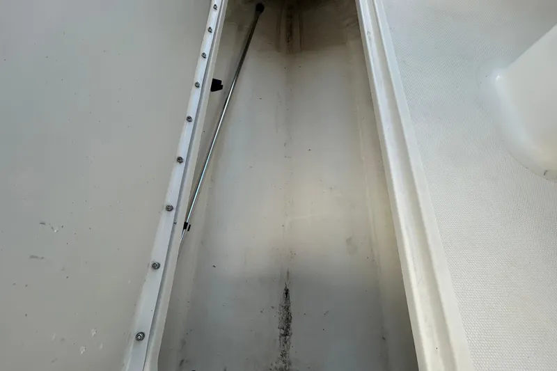 Slide: The Image of Storage compartment of 2020 Sea Ray SPX 210 Outboard boat, showing interior details. - 65