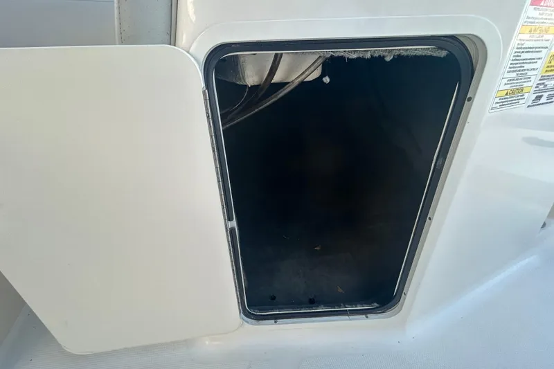 Slide: The Image of Open storage compartment on a 2020 Sea Ray SPX 210 Outboard boat. - 67