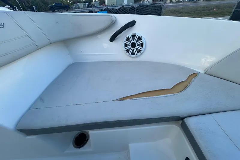 Slide: The Image of 2020 Sea Ray SPX 210 Outboard boat seat with visible tear and speaker. - 74