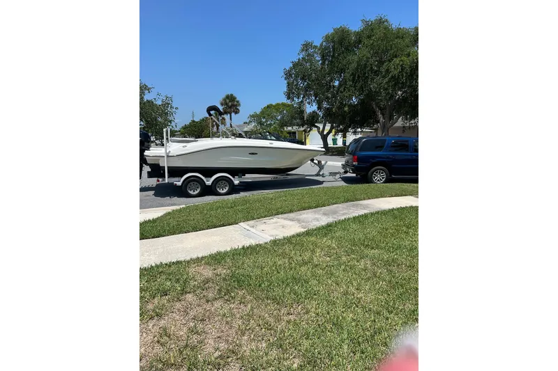 Slide: The Image of 2020 Sea Ray SPX 210 Outboard boat on trailer, under cloudy sky. - 8