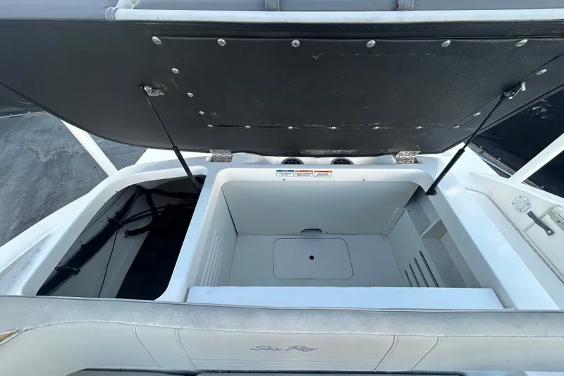 Slide: The Image of 2020 Sea Ray SPX 210 Outboard boat storage compartment open, showcasing spacious interior. - 80