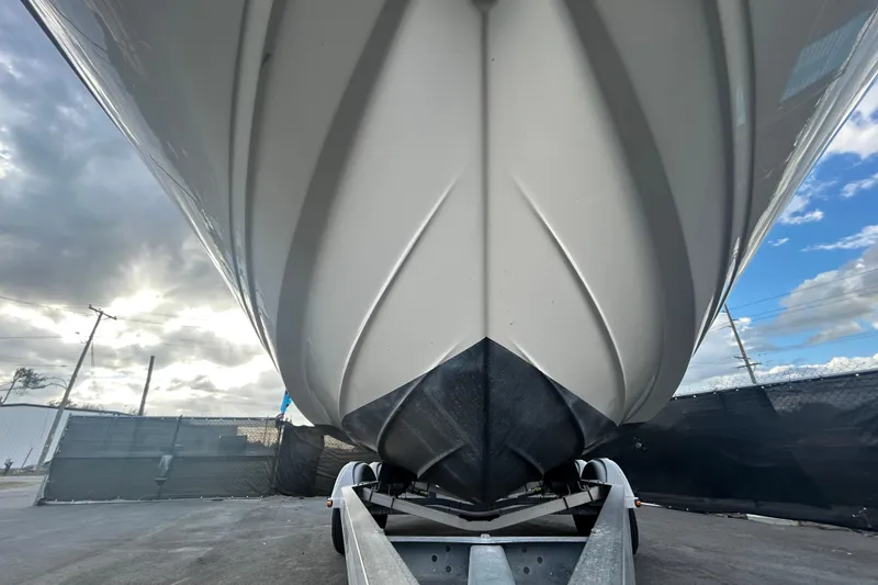 Slide: The Image of 2020 Sea Ray SPX 210 Outboard boat on trailer, viewed from below, with cloudy sky. - 87