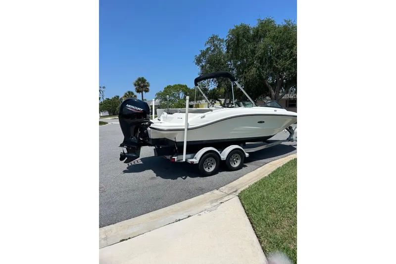 Slide: The Image of 2020 Sea Ray SPX 210 Outboard boat on trailer under cloudy sky. - 9