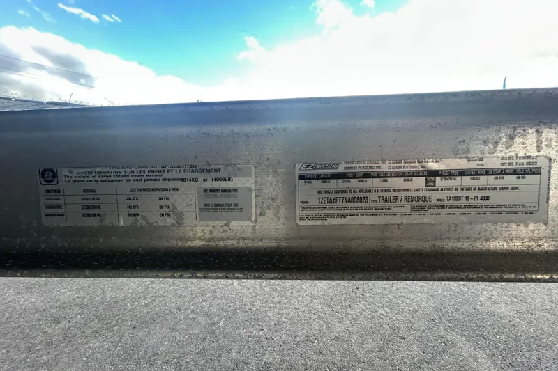 Slide: The Image of 2020 Sea Ray SPX 210 Outboard trailer information labels under a blue sky. - 92