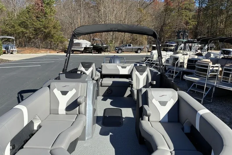 Slide: The Image of 2026 Evotti 521CS pontoon boat with spacious seating, parked outdoors. - 6