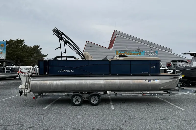 The Image of 2017 Manitou 22RF pontoon boat on trailer in parking lot. - 1
