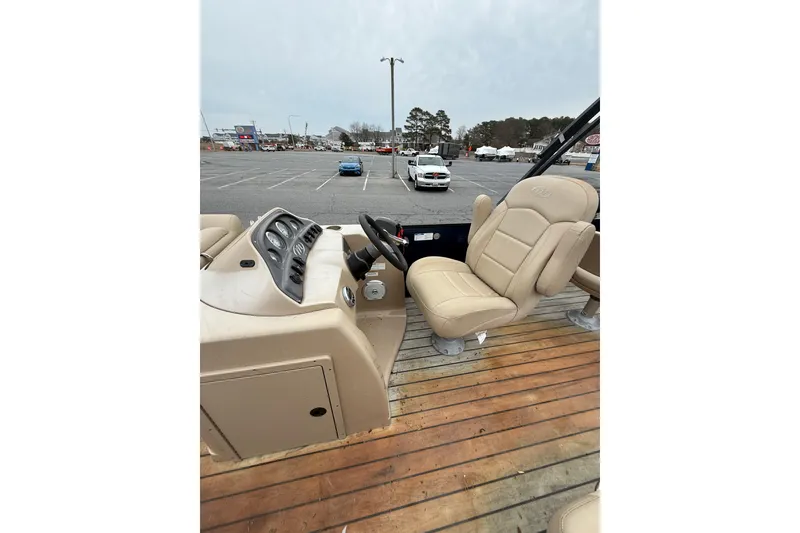 Slide: The Image of 2017 Manitou 22RF boat interior with beige seating and control panel. - 11