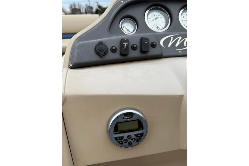 Slide: The Image of Dashboard of a 2017 Manitou 22RF boat with gauges and controls. - 13