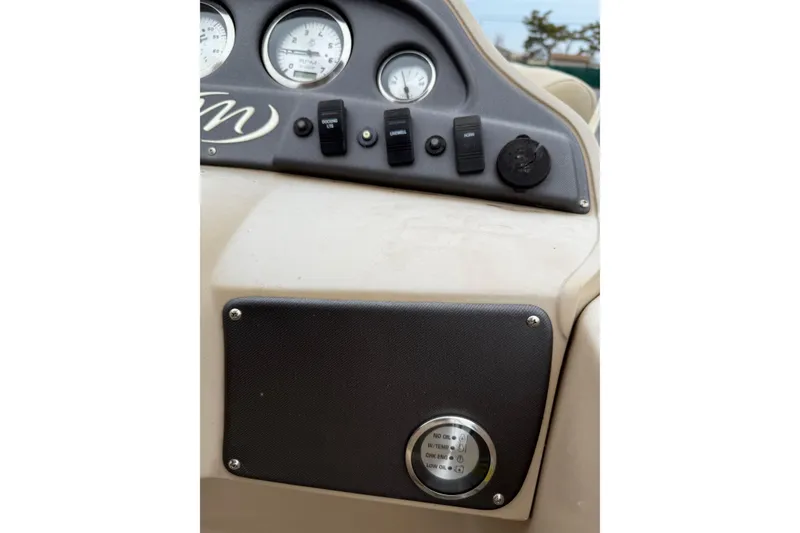 Slide: The Image of Dashboard of a 2017 Manitou 22RF boat with gauges and switches. - 14