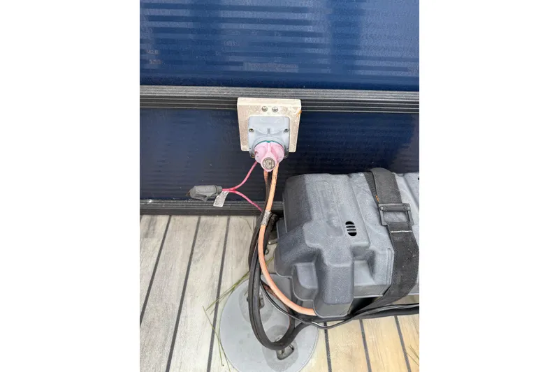 Slide: The Image of Battery connection on a 2017 Manitou 22RF boat, featuring cables and a battery box. - 16