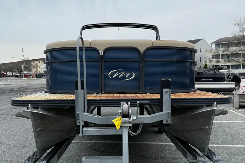 Slide: The Image of 2017 Manitou 22RF pontoon boat on trailer in parking lot. - 3