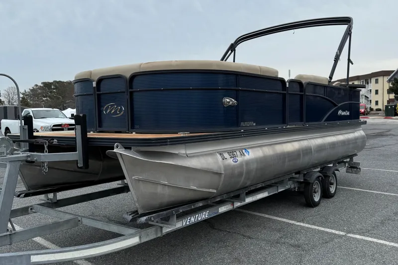 Slide: The Image of 2017 Manitou 22RF pontoon boat on trailer in parking lot. - 4