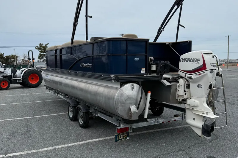 Slide: The Image of 2017 Manitou 22RF pontoon boat with Evinrude motor on trailer in parking lot. - 6