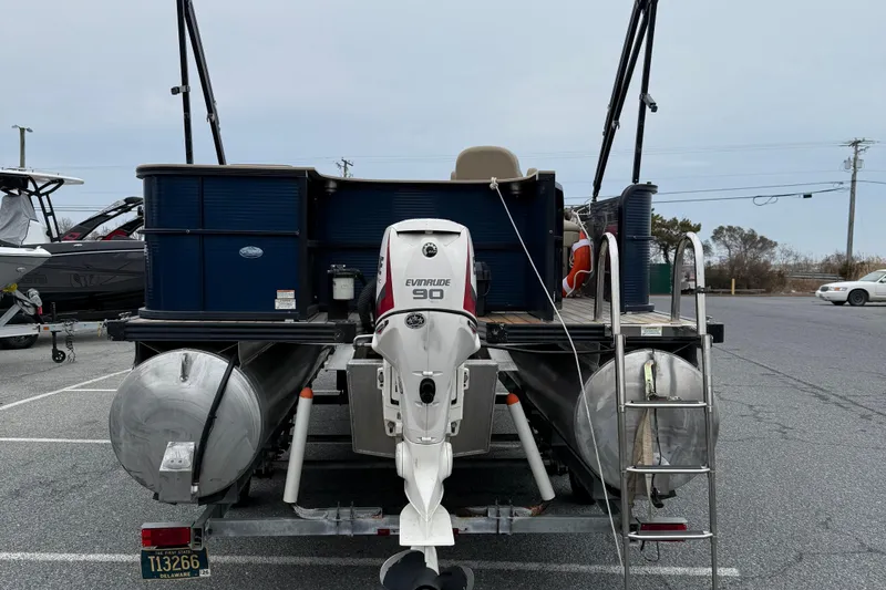 Slide: The Image of 2017 Manitou 22RF pontoon boat with Evinrude 90 engine in parking lot. - 7