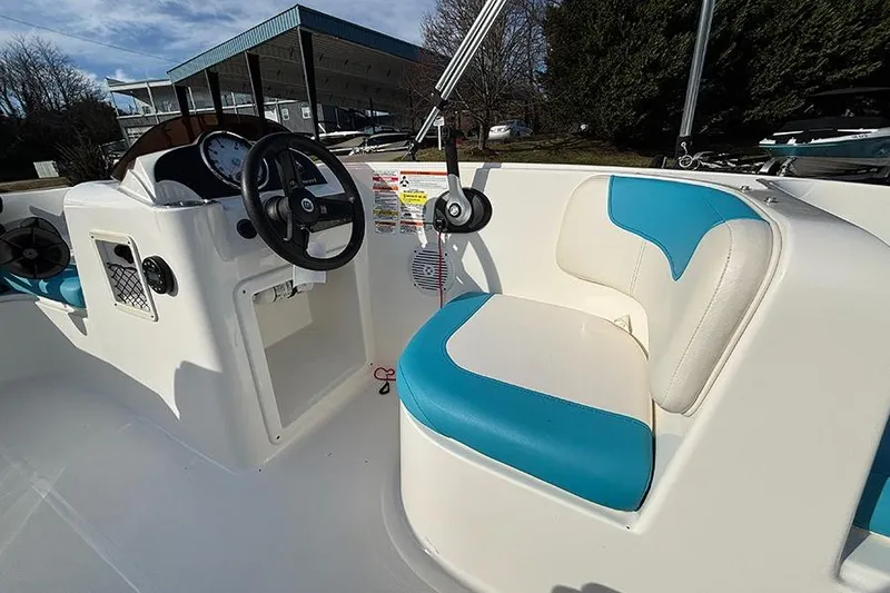 Slide: The Image of 2021 Bayliner Element E16 boat interior with steering wheel and blue-white seating. - 15