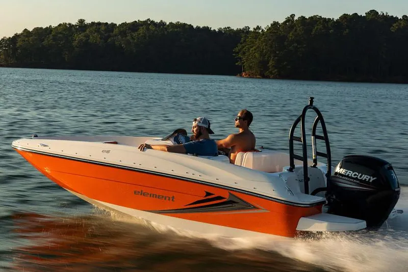 Slide: The Image of 2021 Bayliner Element E16 boat with outboard motor, parked on a trailer. - 2