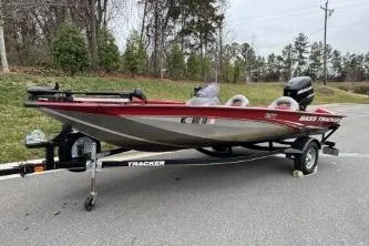Slide: The Image of 2013 Tracker Pro Team 175 TXW bass boat on trailer, parked outdoors. - 7