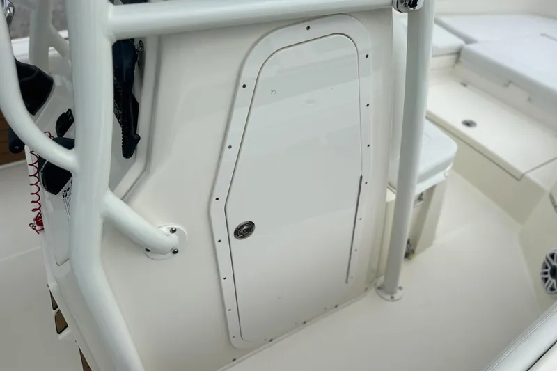 Slide: The Image of 2024 Pathfinder 2400 TRS boat interior with white console and storage compartment. - 14