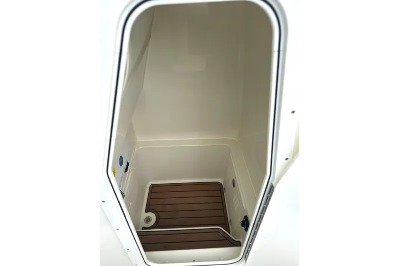 Slide: The Image of 2024 Pathfinder 2400 TRS boat storage compartment with wooden flooring detail. - 15