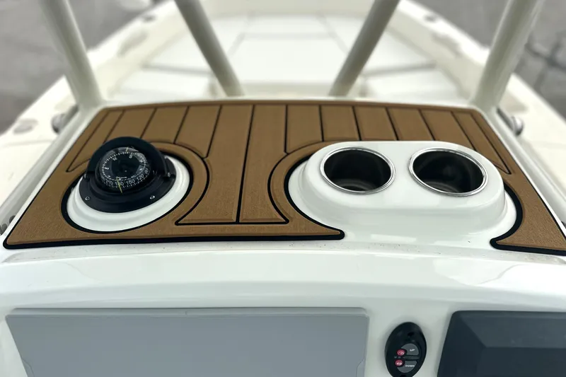 Slide: The Image of 2024 Pathfinder 2400 TRS boat dashboard with compass and cup holders. - 16