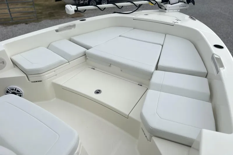 Slide: The Image of 2024 Pathfinder 2400 TRS boat interior with cushioned seating and storage compartments. - 17