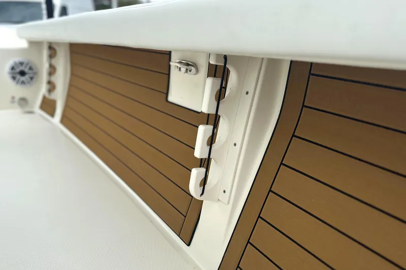 Slide: The Image of 2024 Pathfinder 2400 TRS boat interior with wood paneling and speaker detail. - 19