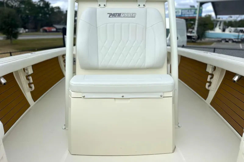 Slide: The Image of 2024 Pathfinder 2400 TRS boat interior with white cushioned seat and wood accents. - 20